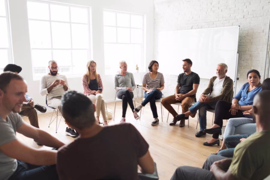 a circle of people sitting and talking